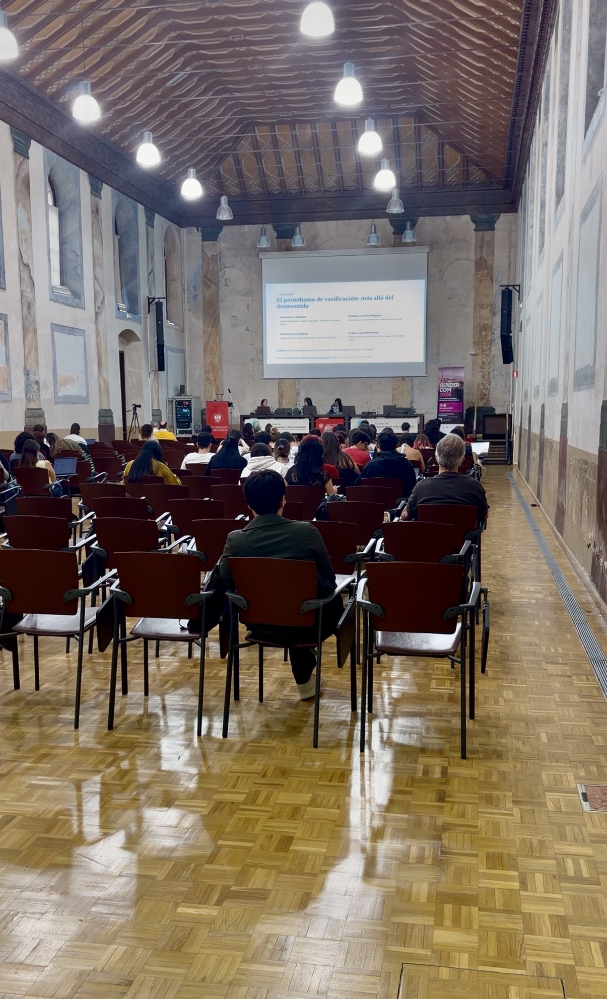 Público en el salón de actos durante una ponencia de GENDERCOM 2026